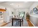 Well-lit dining room with a wooden table, sliding doors to the backyard, and access to the kitchen at 4338 S Alton St, Greenwood Village, CO 80111