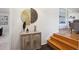 Stylish entryway with decorative accents, a wooden cabinet, and a staircase leading to the upper level at 4338 S Alton St, Greenwood Village, CO 80111