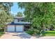 Two-story home featuring a large front yard with mature trees and a two-car garage at 4338 S Alton St, Greenwood Village, CO 80111