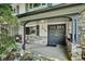 Charming covered porch with stone accents leads to a stylish front door, enhancing curb appeal at 4338 S Alton St, Greenwood Village, CO 80111