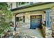 Charming covered front porch with stone accents and seating area, perfect for relaxing outdoors at 4338 S Alton St, Greenwood Village, CO 80111