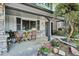 Inviting covered front porch featuring stone accents and a cozy seating area, perfect for relaxing at 4338 S Alton St, Greenwood Village, CO 80111