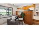 Cozy living area with a comfortable chair, side table, and view into a kitchen space at 4338 S Alton St, Greenwood Village, CO 80111