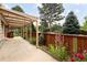 Inviting backyard patio with pergola, wooden fence and garden, creating a serene space for outdoor enjoyment at 141 S Upham Ct, Lakewood, CO 80226