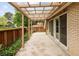 Spacious backyard patio area with covered pergola, brick accents, and wooden fence, ideal for outdoor living at 141 S Upham Ct, Lakewood, CO 80226