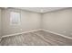 Finished basement bedroom with egress window and laminate flooring at 141 S Upham Ct, Lakewood, CO 80226