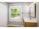 Updated bathroom with window, vanity, and hardwood floors at 141 S Upham Ct, Lakewood, CO 80226