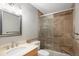 Bathroom featuring glass enclosed shower with built-in seat and neutral finishes at 141 S Upham Ct, Lakewood, CO 80226