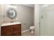 Bathroom featuring vanity, framed mirror, and glass-enclosed shower at 141 S Upham Ct, Lakewood, CO 80226