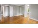 Bedroom with hardwood floors, neutral walls, and a closet with mirrored doors at 141 S Upham Ct, Lakewood, CO 80226