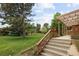 Beautifully landscaped yard with a covered patio leading to the home at 141 S Upham Ct, Lakewood, CO 80226