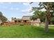Charming home with well-maintained lawn, wooden fence, and mature trees, creating a welcoming curb appeal at 141 S Upham Ct, Lakewood, CO 80226