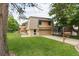 Two-story home with a well-maintained lawn and mature trees at 141 S Upham Ct, Lakewood, CO 80226