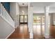 Elegant foyer with hardwood floors, columns, and ample natural light at 141 S Upham Ct, Lakewood, CO 80226
