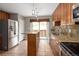 Bright kitchen with stainless steel refrigerator and access to the outdoor area at 141 S Upham Ct, Lakewood, CO 80226