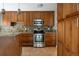 Kitchen featuring modern appliances and custom wood cabinetry at 141 S Upham Ct, Lakewood, CO 80226