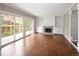Spacious living room featuring a fireplace, built-in shelving and sliding glass doors to the patio at 141 S Upham Ct, Lakewood, CO 80226
