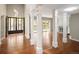 Open-concept living room with hardwood floors, columns, and natural light at 141 S Upham Ct, Lakewood, CO 80226