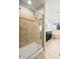 Bright bathroom featuring a glass shower, dark vanity, and soaking tub near a window at 17857 Lapis Ct, Monument, CO 80132