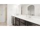 Bathroom featuring double sinks, ample counter space, and a separate shower, perfect for morning routines at 17857 Lapis Ct, Monument, CO 80132