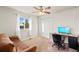 Carpeted bedroom with a futon, ceiling fan, and large window at 17857 Lapis Ct, Monument, CO 80132