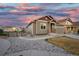 Charming single Gathering house featuring a two-car garage, beautiful siding and colorful sunset in the background at 17857 Lapis Ct, Monument, CO 80132