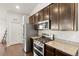 Well-equipped kitchen featuring stainless steel appliances, gas range, granite countertops, and hardwood floors at 17857 Lapis Ct, Monument, CO 80132