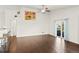 Open living room features hardwood floors, ceiling fan, and sliding glass door providing access to the backyard at 17857 Lapis Ct, Monument, CO 80132