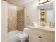 Cozy bathroom featuring mosaic tile in shower/bath, and a vanity with storage, offering a functional space at 645 Manhattan Pl # 106, Boulder, CO 80303