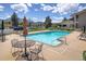 Community pool with metal tables and chairs for residents to relax by the poolside at 645 Manhattan Pl # 106, Boulder, CO 80303
