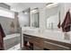 Sleek bathroom with double vanity, square sinks, modern fixtures, and a glass-enclosed shower-tub combo at 4539 Tennyson St # 105, Denver, CO 80212