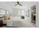 Inviting bedroom showcasing neutral tones, plush bedding, a stylish rug, and an ensuite bathroom at 4539 Tennyson St # 105, Denver, CO 80212