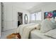 Comfortable bedroom with attached bathroom, featuring soft carpet, a window, and art at 4539 Tennyson St # 105, Denver, CO 80212
