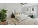 Bright bedroom with a large window, neutral decor, textured rug, and a comfortable seating area at 4539 Tennyson St # 105, Denver, CO 80212