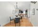 Open-concept dining area with hardwood floors and modern lighting with partial view of kitchen at 4539 Tennyson St # 105, Denver, CO 80212