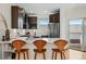 Modern kitchen with stainless steel appliances, island seating, and quartz countertops at 4539 Tennyson St # 105, Denver, CO 80212