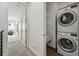 Bright laundry area featuring a stackable washer and dryer, and shelving for storage at 4539 Tennyson St # 105, Denver, CO 80212