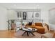 Open loft living area with hardwood floors, modern railing, comfortable seating and natural light at 4539 Tennyson St # 105, Denver, CO 80212