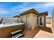 Outdoor hot tub on a rooftop deck with wooden flooring and blue sky at 4539 Tennyson St # 105, Denver, CO 80212