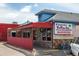 Exterior view of Puerto Vallarta Mexican Restaurant Mariscos with stone accents and a red fence at 3728 W 1St Ave, Denver, CO 80219