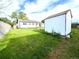 Backyard view showing lawn, garden area, privacy fence, shed and back of house at 4312 S Xenon St, Morrison, CO 80465