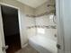 Clean and modern bathroom showcasing a bathtub with tiled surround at 4312 S Xenon St, Morrison, CO 80465