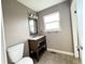 Cozy bathroom featuring a stylish vanity, toilet, and tile flooring at 4312 S Xenon St, Morrison, CO 80465