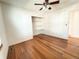 Bright bedroom featuring hardwood floors, closet space with shelves, and a ceiling fan at 4312 S Xenon St, Morrison, CO 80465