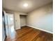 Bedroom featuring hardwood floors, closet space, and neutral paint, creating a comfortable atmosphere at 4312 S Xenon St, Morrison, CO 80465