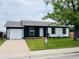 Charming home with a well-manicured lawn, a garage, and a 'For Sale' sign at 4312 S Xenon St, Morrison, CO 80465