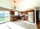 Well-lit kitchen featuring stainless steel appliances, tile flooring, and sliding door access to the backyard at 4312 S Xenon St, Morrison, CO 80465