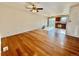 Spacious living room with hardwood floors, ceiling fan, and seamless transition into dining area at 4312 S Xenon St, Morrison, CO 80465