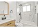 Bright bathroom features a tub with black fixtures and stylish marble-look tile at 9101 Clarkson St, Thornton, CO 80229