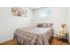 Cozy bedroom with warm hardwood floors, natural lighting, and neutral tones, offering a relaxing and comfortable space at 9101 Clarkson St, Thornton, CO 80229